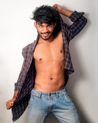 A confident young man posing casually in a stylish outfit symbolizing the call boys category