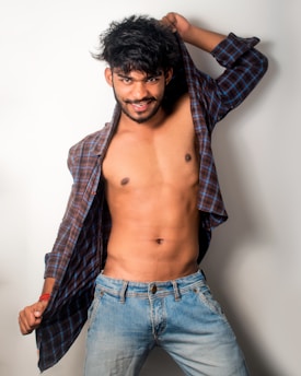 A confident young man posing casually in a stylish outfit symbolizing the call boys category