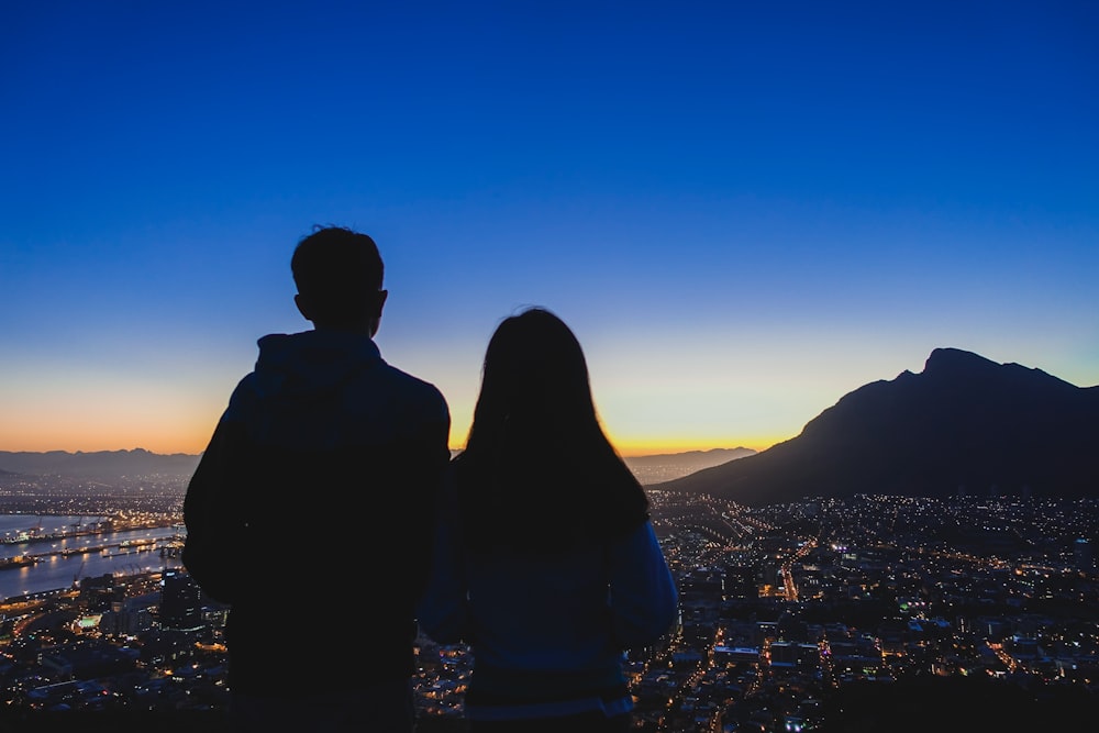 man and woman watching night view