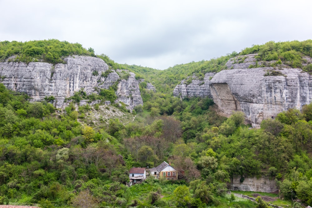 white concrete house below rock formation