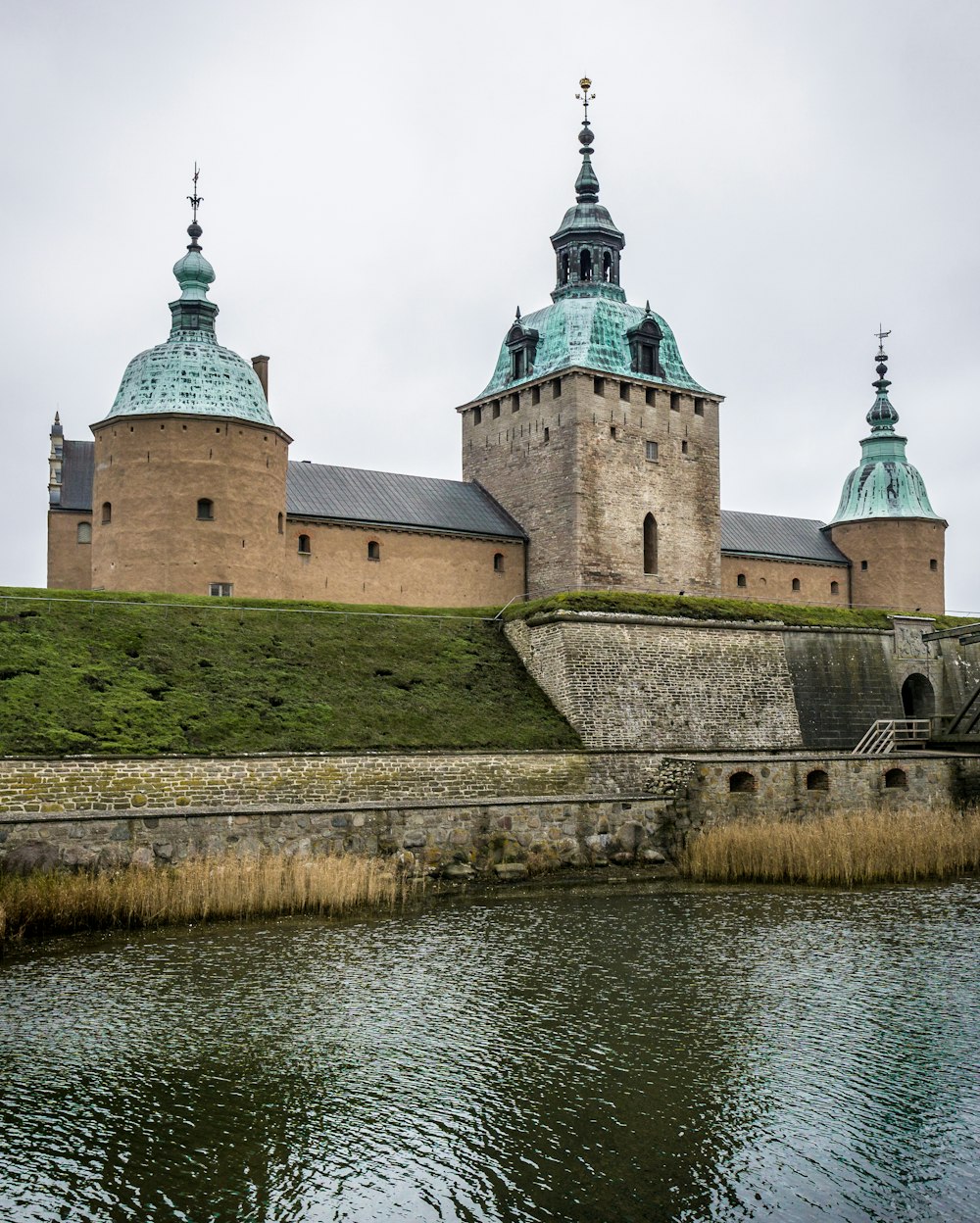 brown fort beside body of water