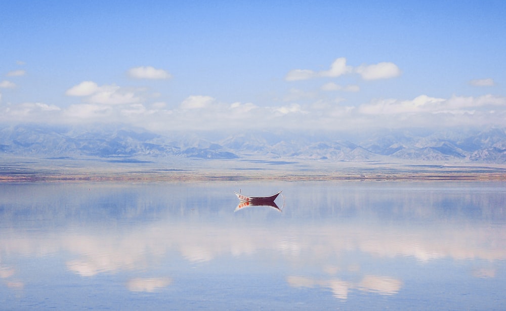 a large body of water with mountains in the background