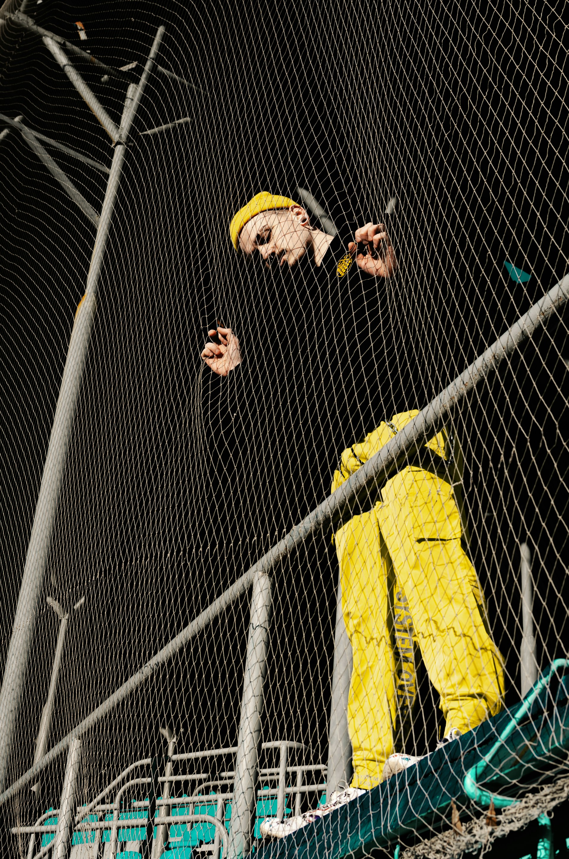 man wearing black shirt and yellow pants