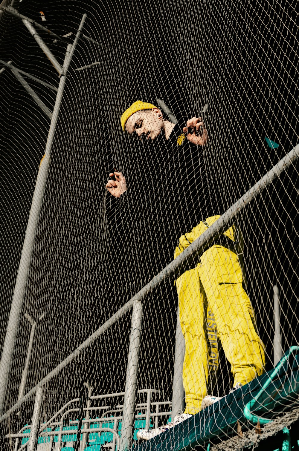 man wearing black shirt and yellow pants