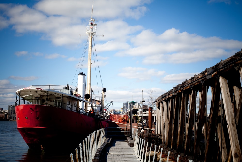 red and white sail boat