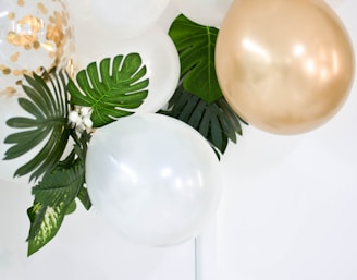two gold and white balloons