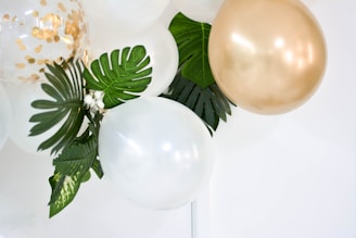 two gold and white balloons
