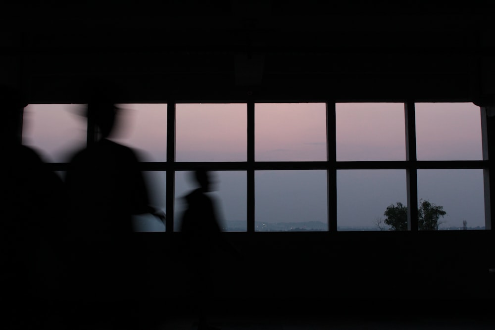 silhouette of standing near window