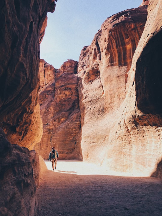 man walking beside valley in Petra Jordan