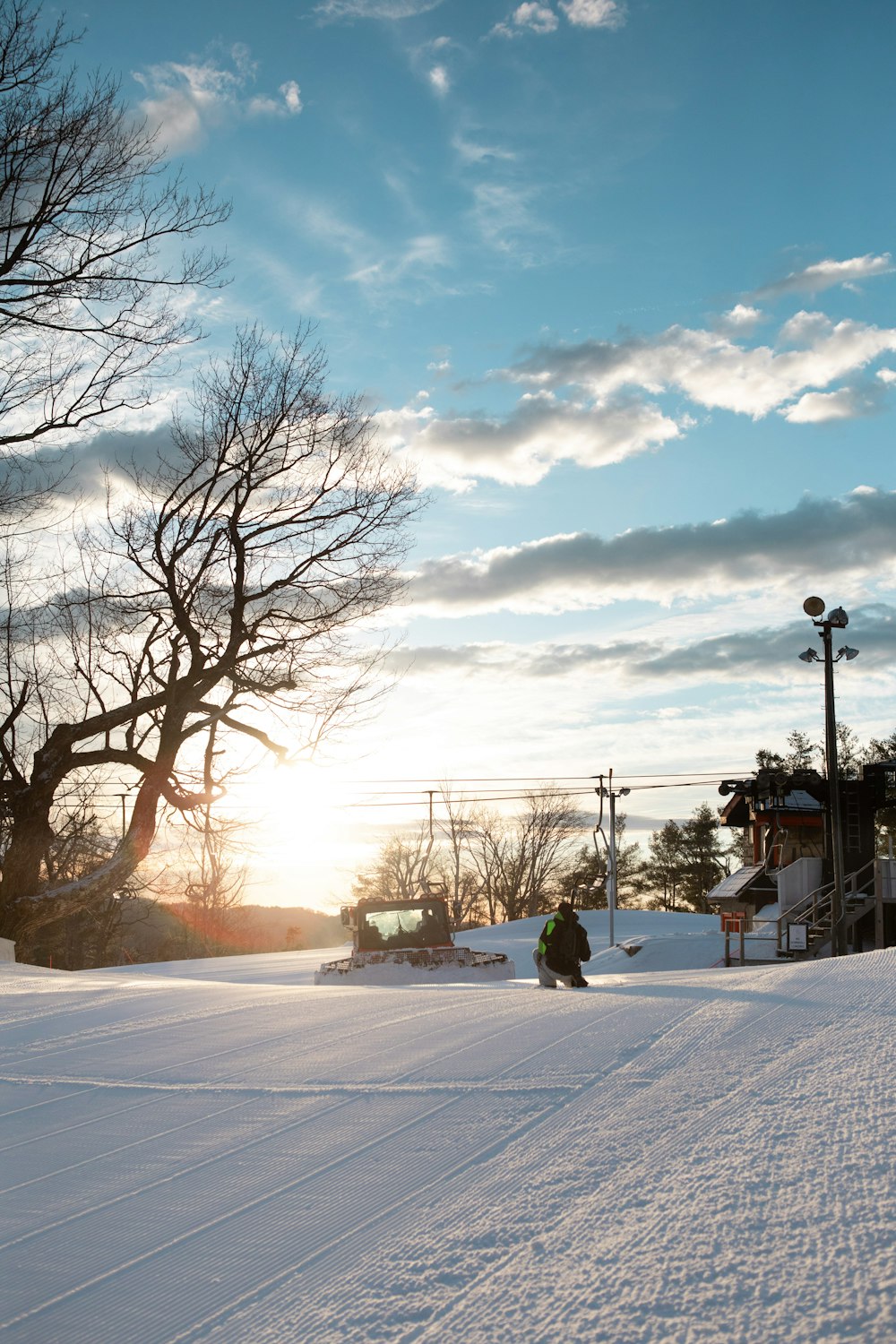 person sitting on snow covered ground