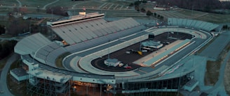 Aerial view of the racetrack with packed stands and vibrant atmosphere.