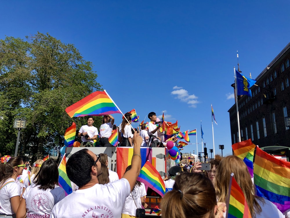 people holding multicolored flags