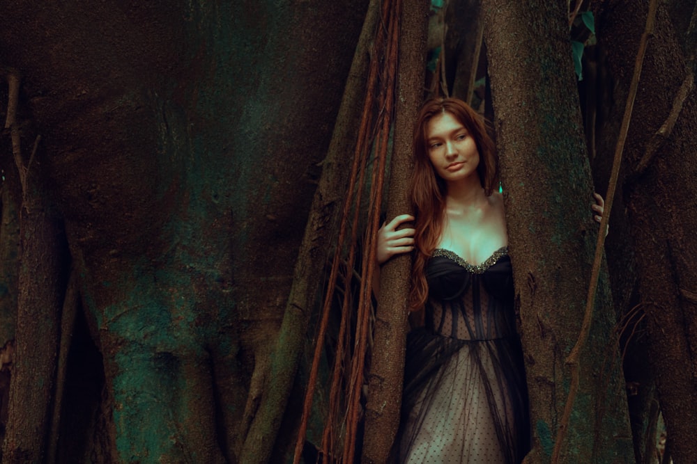 woman standing in between trees