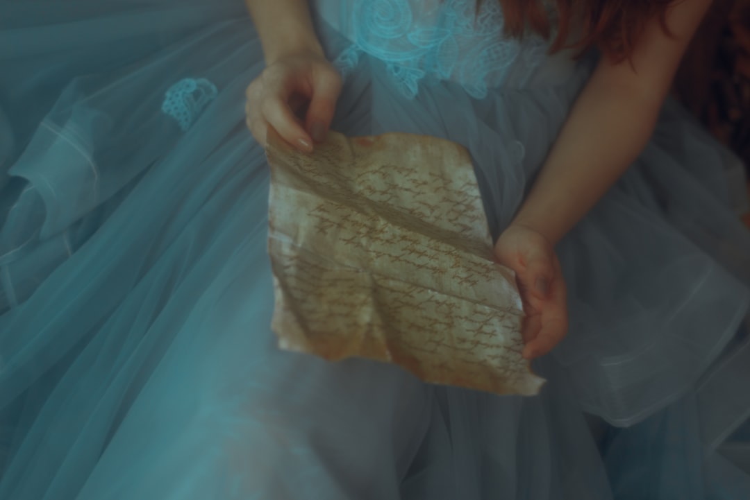 a woman in a blue dress holding a piece of paper,
