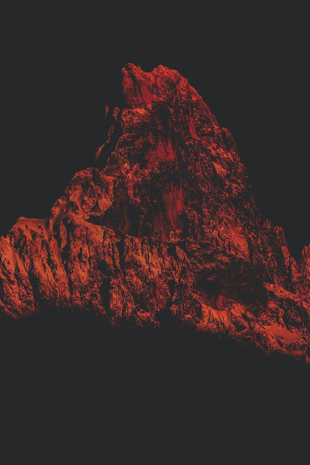 a red mountain is shown against a black background