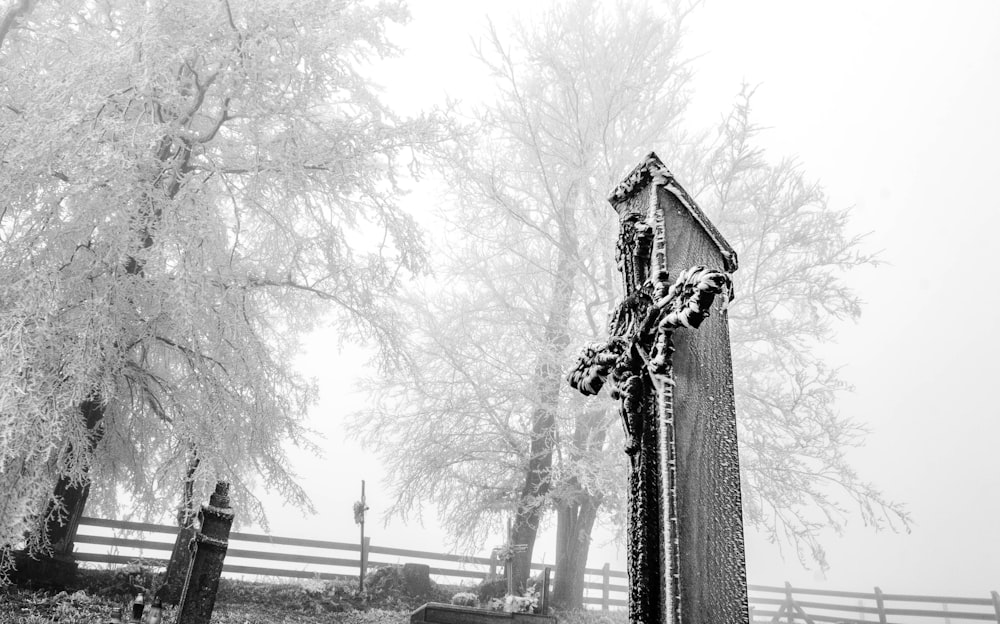 grayscale photo of cross tombstone