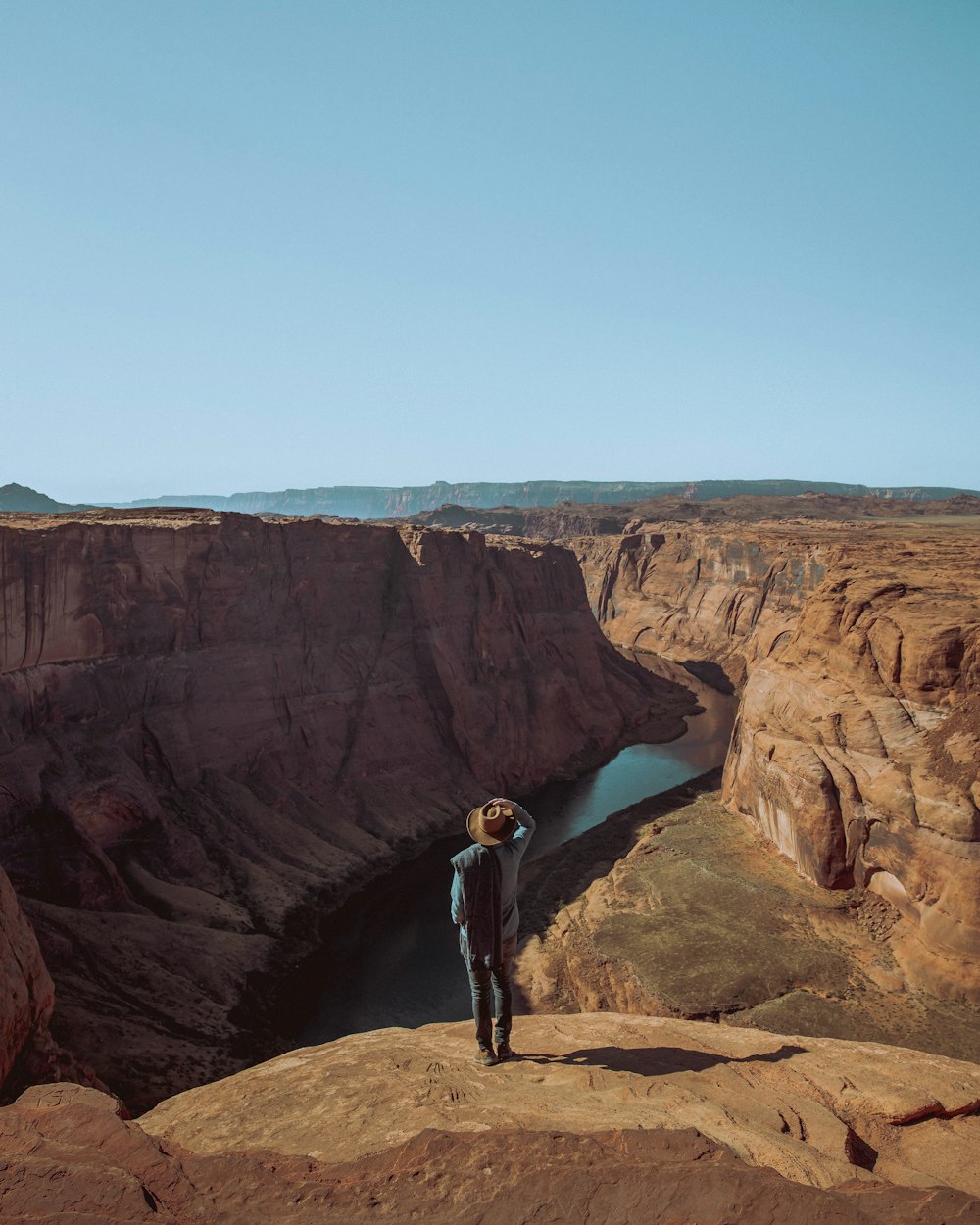 man standing on rock edge