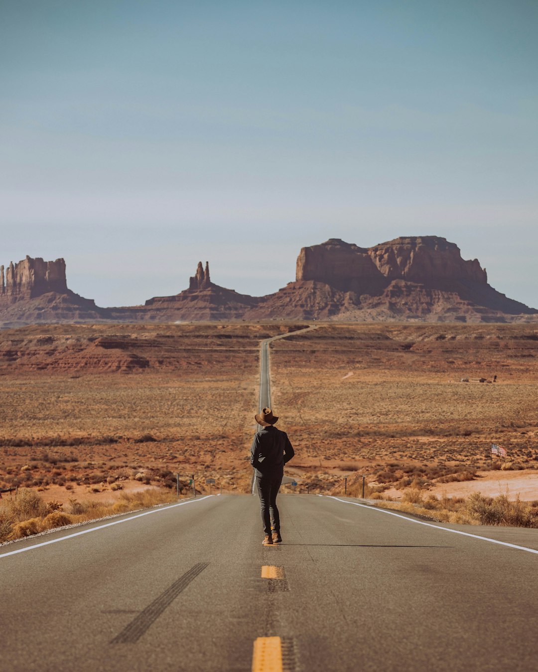 man standing in the middle of road