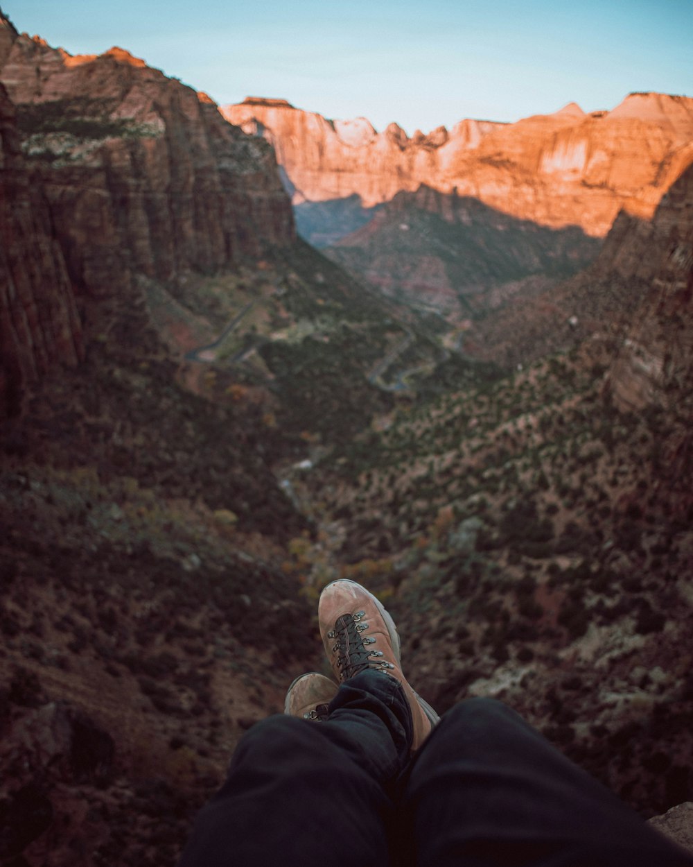 person sitting on cliff