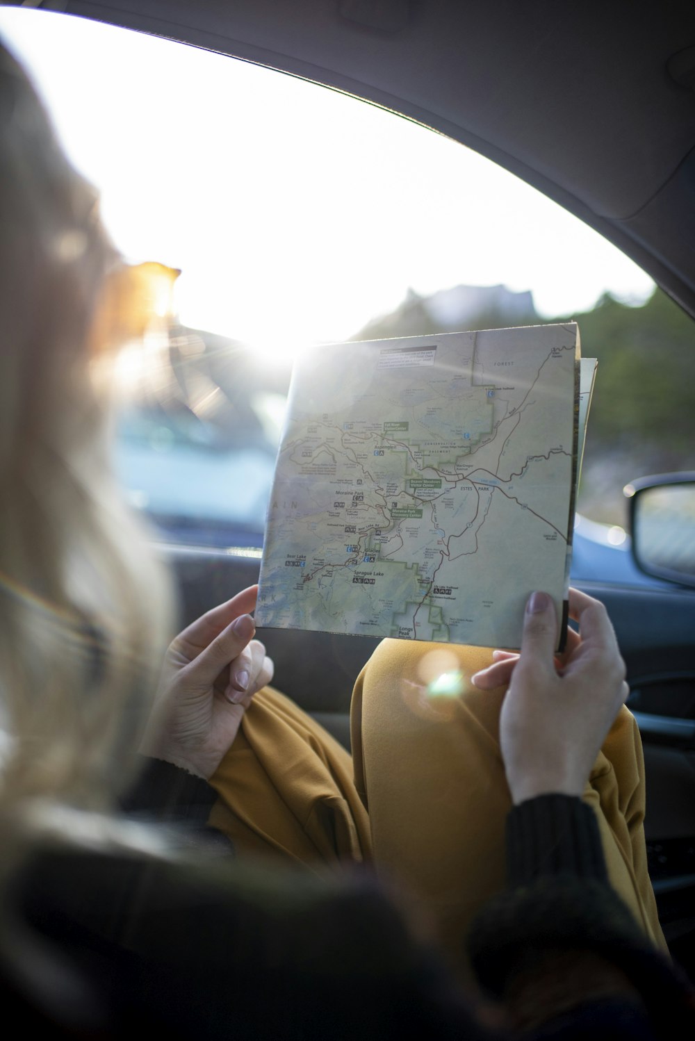 woman wearing yellow dress holding city map