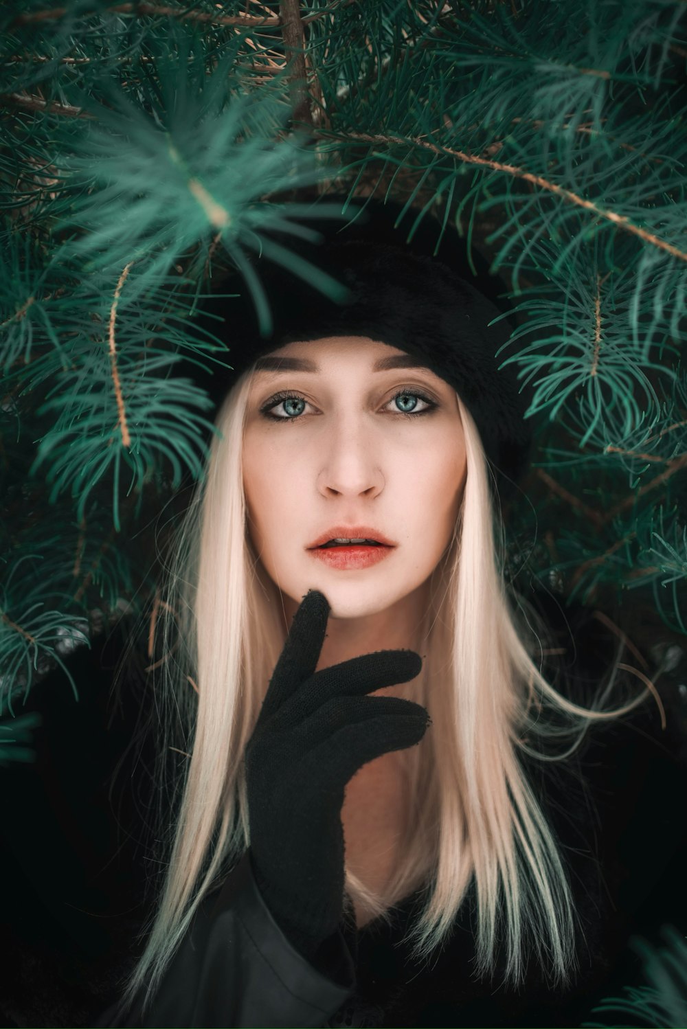 portrait of woman wearing black bennies and black coat