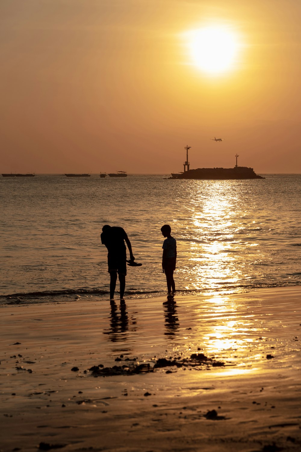 silhouette of person standing on seashore