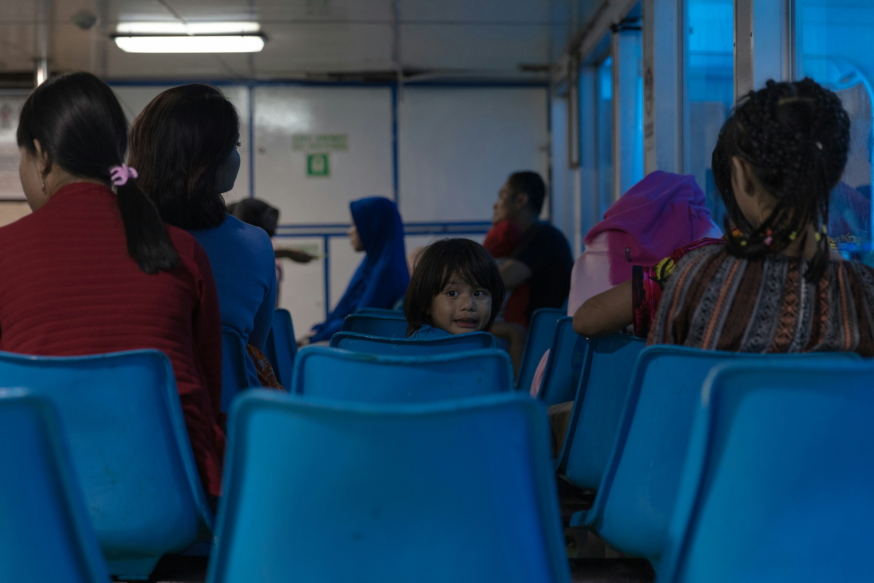 people sitting on blue gang chairs