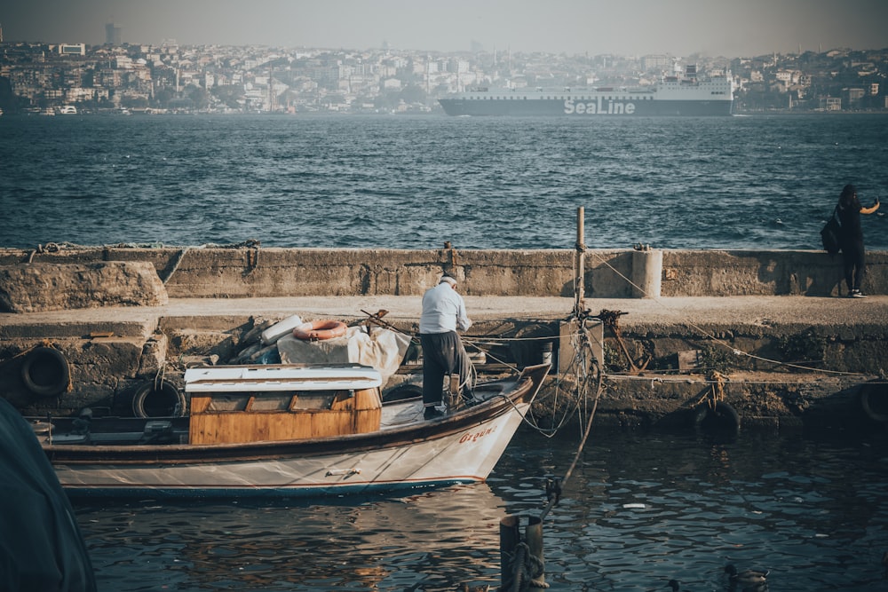 person riding brown wooden canoe