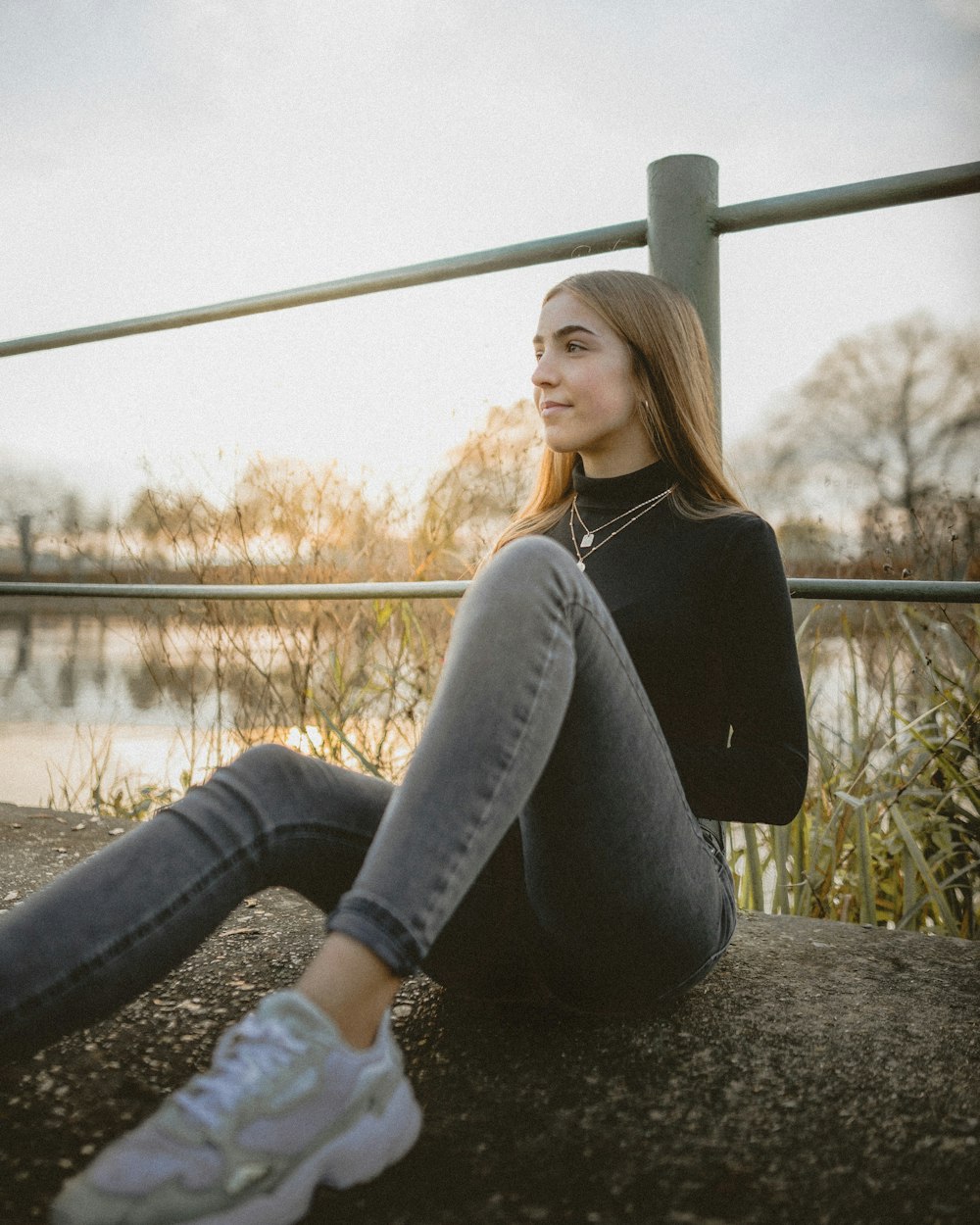 woman wearing black sweater and gray jeans