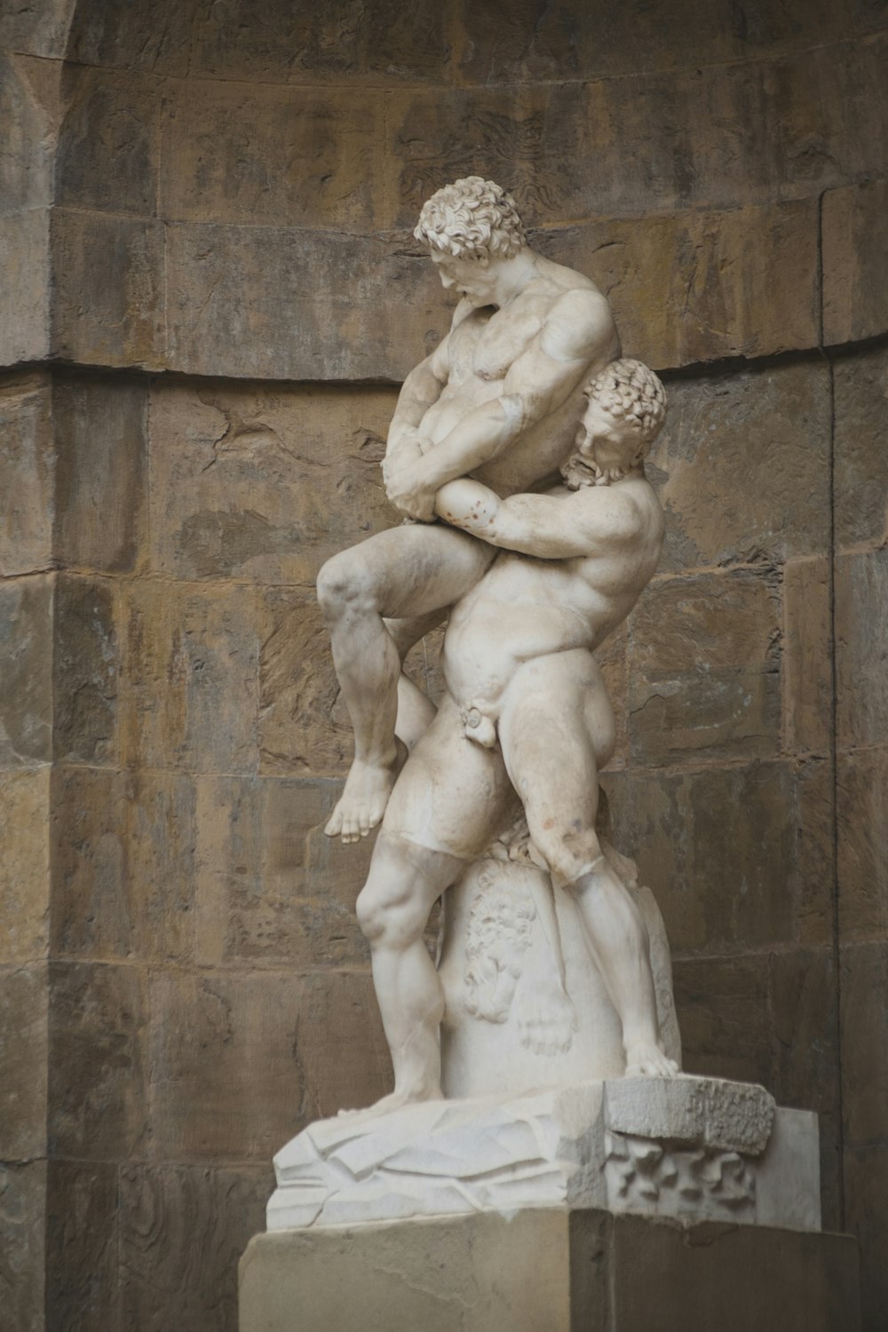 nude man carrying man statue