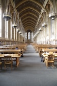 A peaceful study hall with individuals engaged in learning.