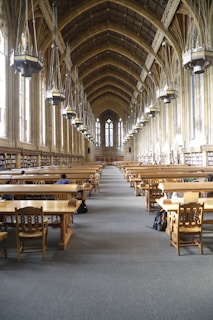 A group of dedicated scholars studying together in a warm, sunlit study hall in Jerusalem.