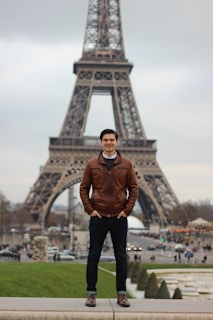 An inspirational scene of a student standing in front of an iconic European landmark, looking hopeful.