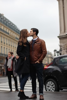 man and woman kissing on street during daytime
