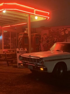 A vintage gas station with rustic signage and warm lighting.