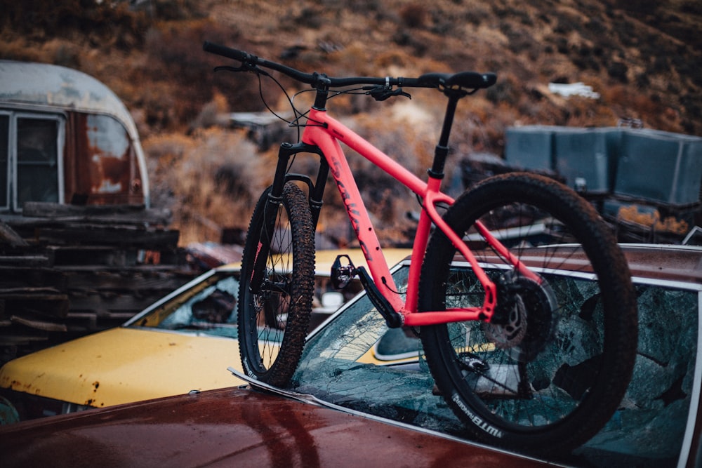 pink and black commuter bike on brown car