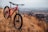 red and black hardtail bike on brown grass field