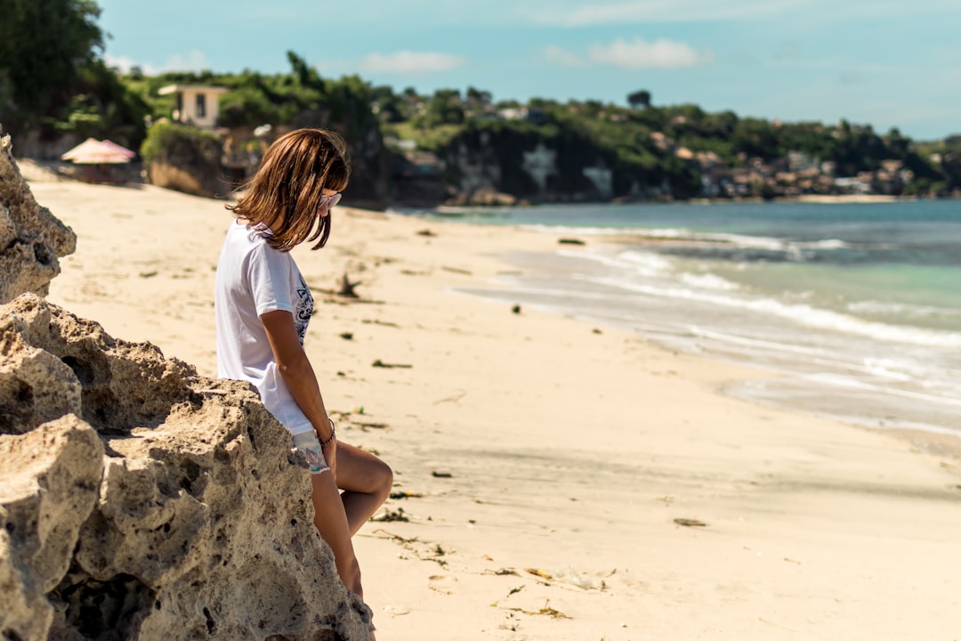 woman sitting on rock