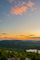 A scenic view of a mountain landscape at sunset.