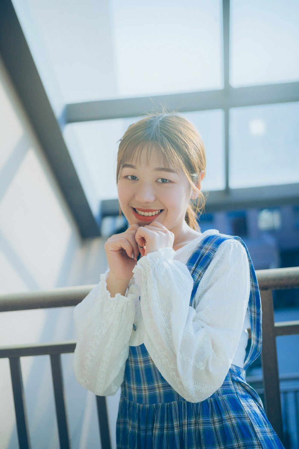 smiling girl beside railing