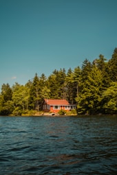 Seasonal cottage on a rocky shoreline overlooking Kahshe Lake.