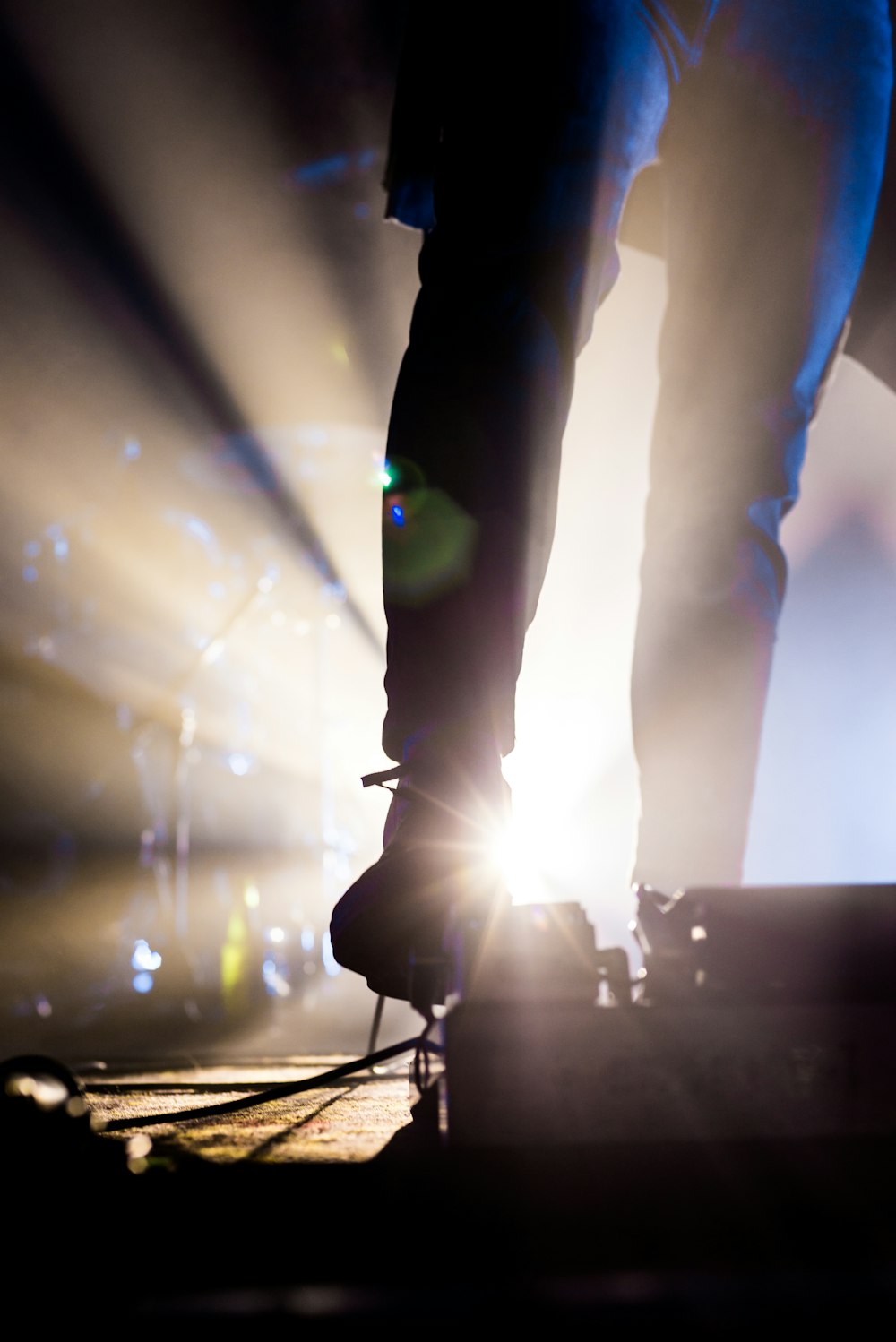 a person standing on a stage with their feet up