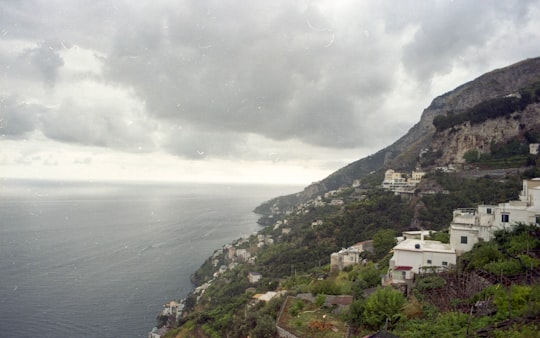 aerial photography of houses in mountain near sea during daytime in Amalfi Italy