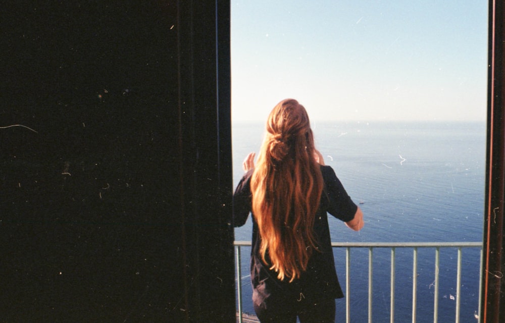 woman standing near steel balustrade