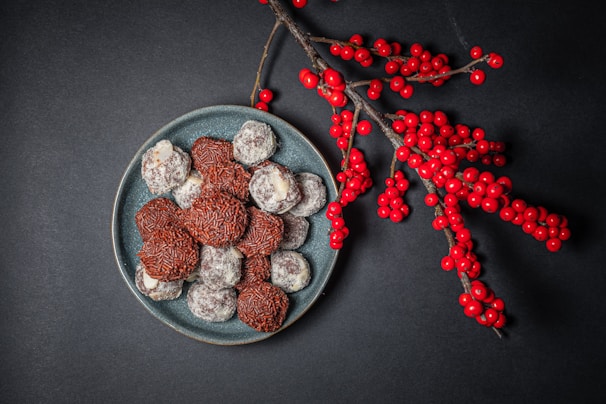 Close-up of assorted gourmet brigadeiros arranged elegantly on a modern ceramic plate