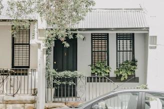 A freshly painted blue exterior of a Laval home under soft natural light.