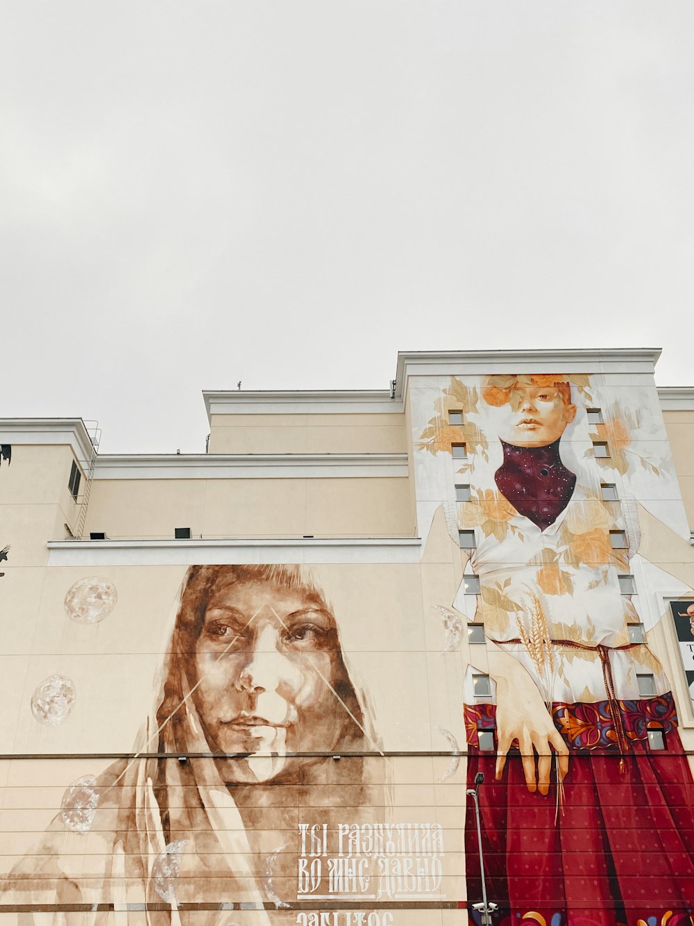 two women graphic painting on high-rise building