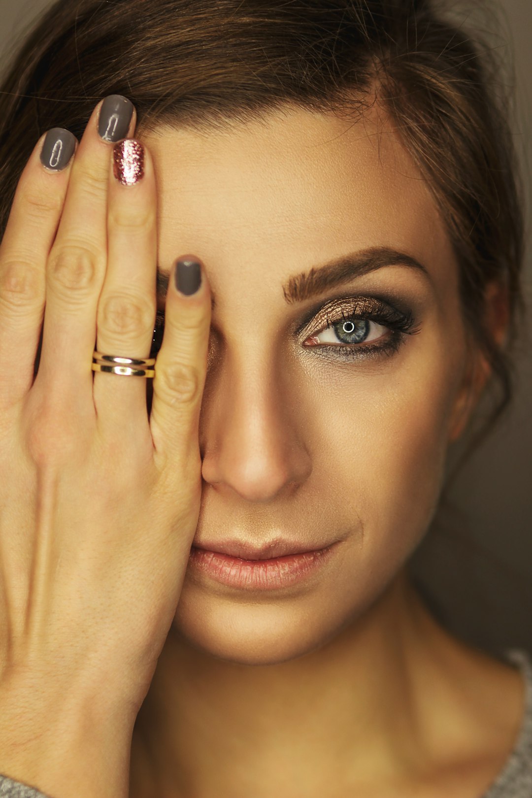 portrait of woman wearing gold-colored band ring