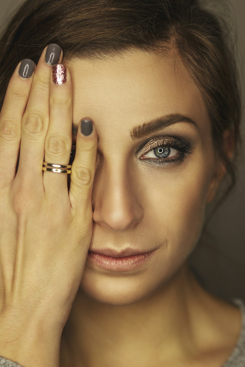 portrait of woman wearing gold-colored band ring