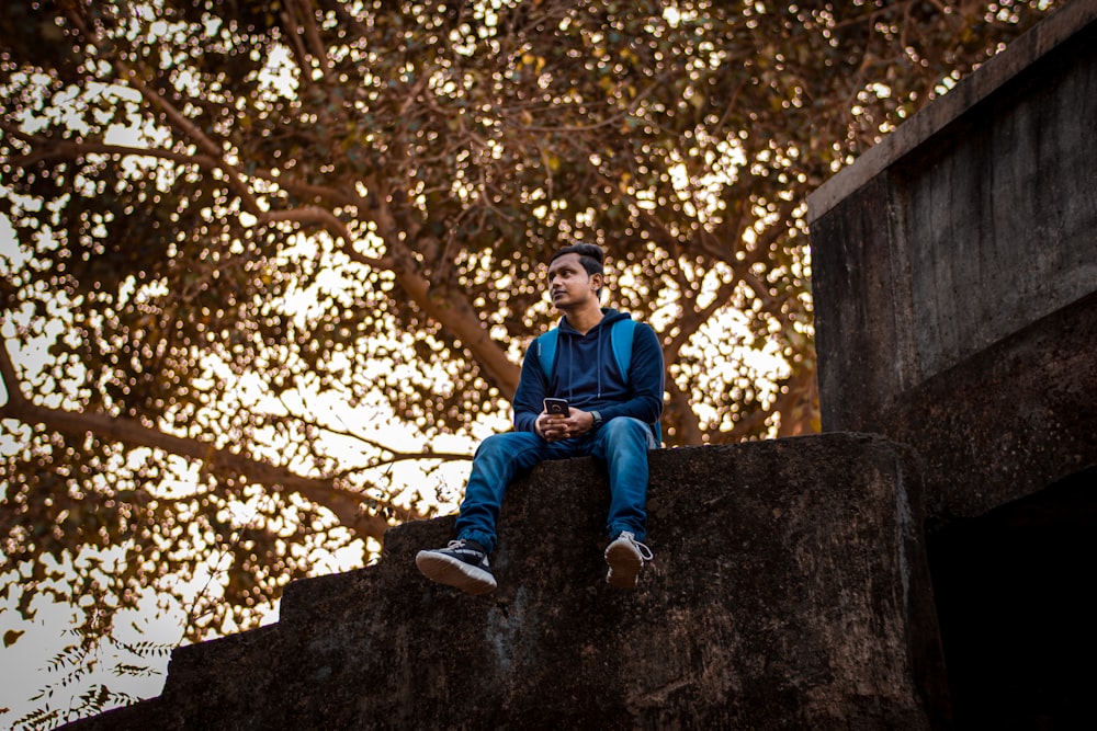 man sitting on wall